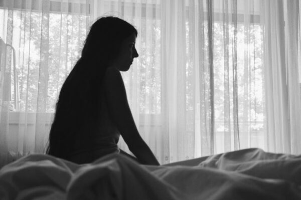 sad-woman-sitting-in-bedroom-2022-11-16-23-42-15-utc
