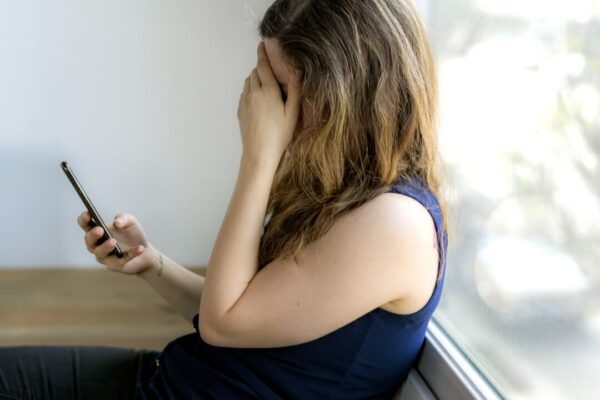 sad-woman-with-a-phone-2022-12-16-01-01-52-utc
